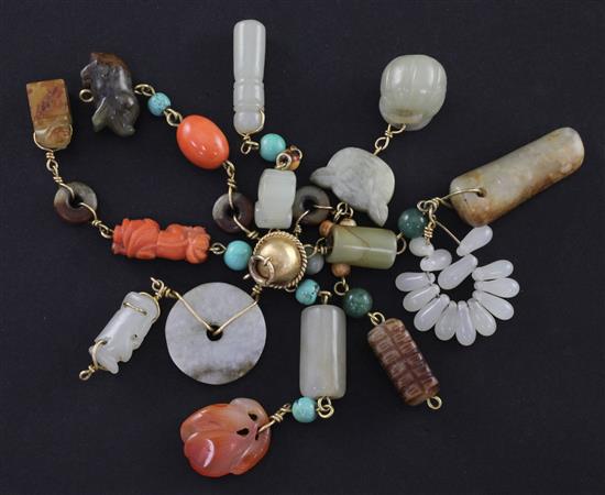 A collection of Chinese jade, hardstone and coral pendants and beads, mounted in gold, 19th / early 20th century, total length when sus